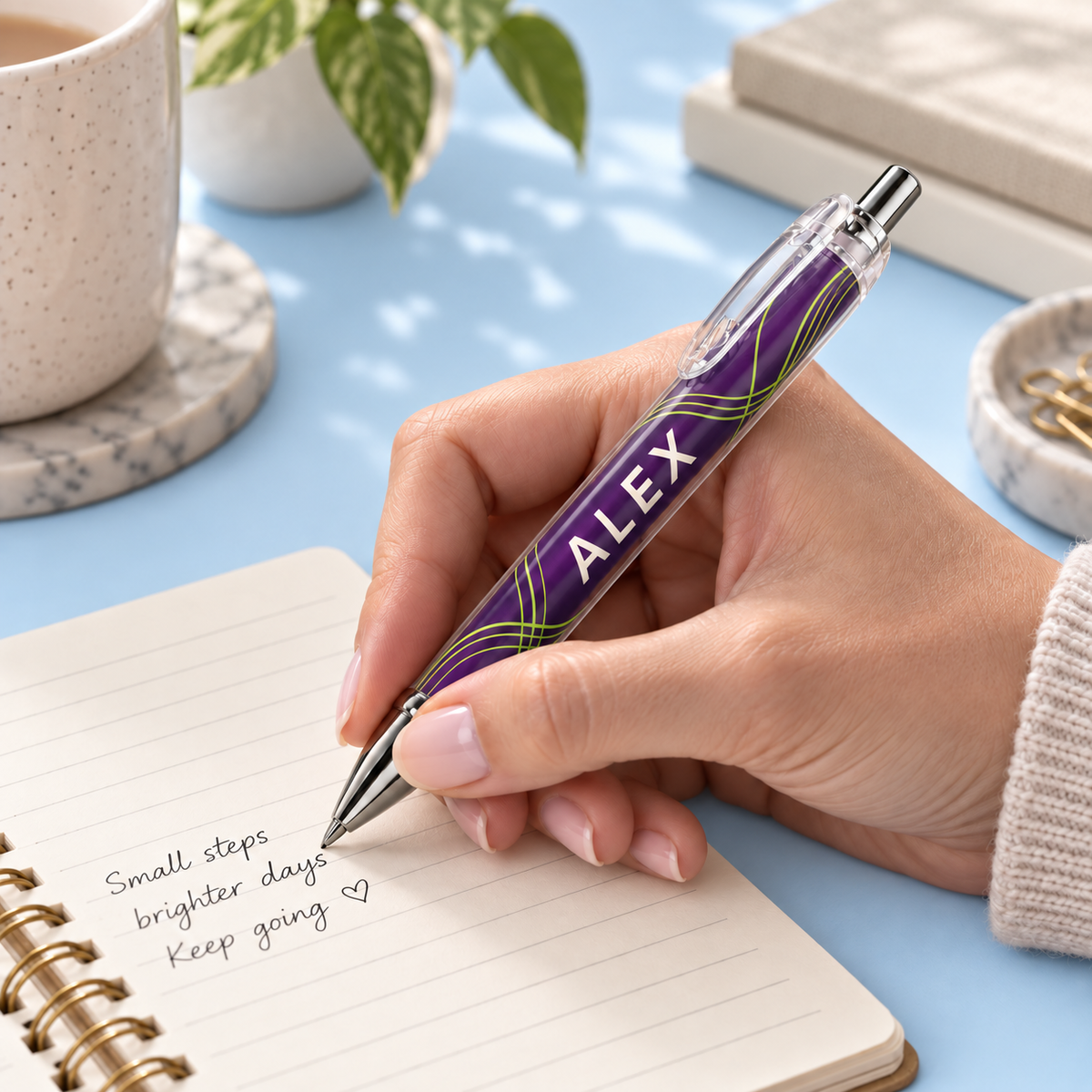 Shared ScribbleRush adult hand writing with an ALEX pen on light sky blue. Design mockup; example for all pack sizes.